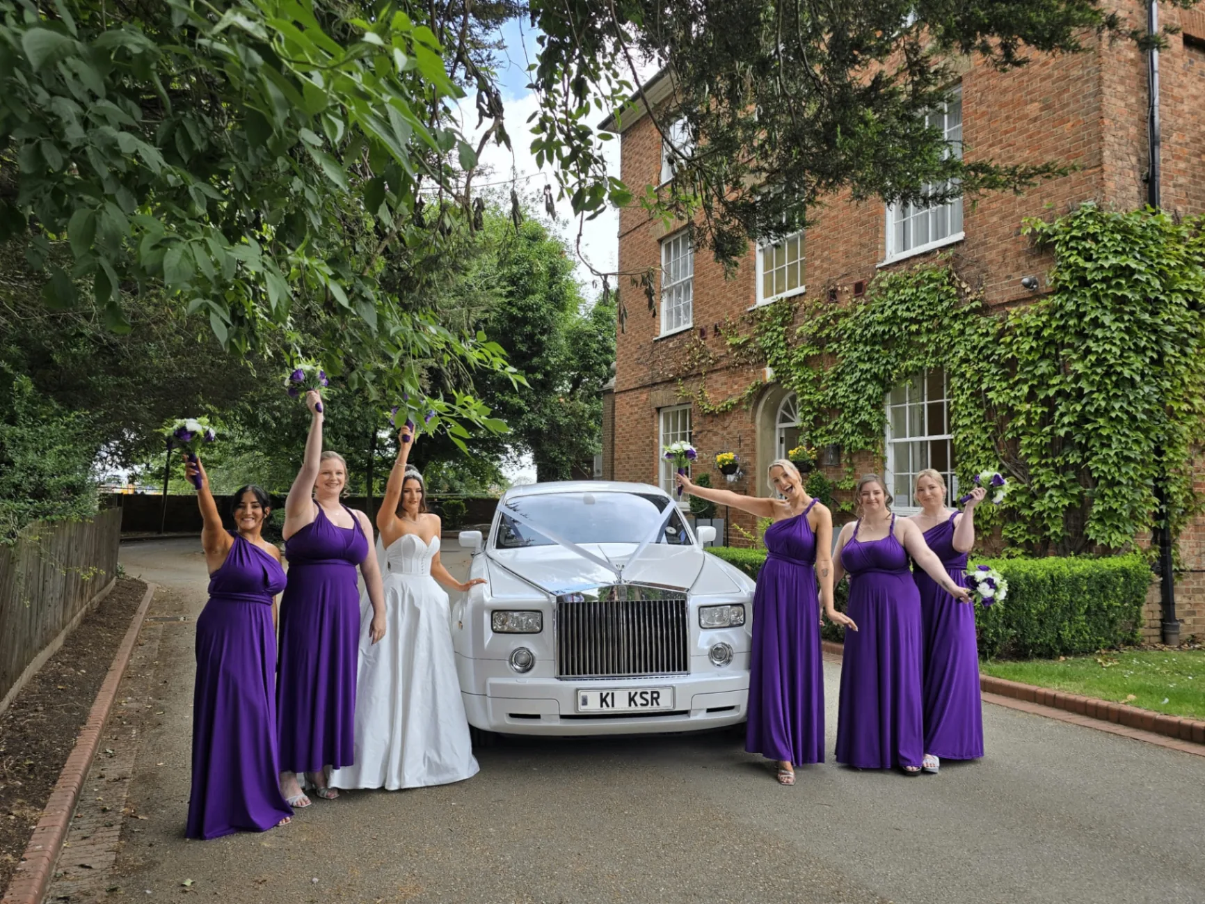 Wedding Car Hire — couple celebrating beside a chauffeur-driven car